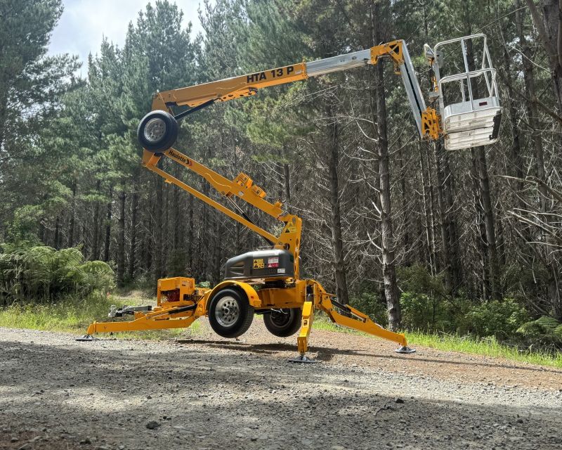 yellow trailer boom in bush setting